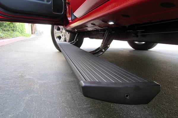 AMP Research PowerStep automatic running boards deployed on truck